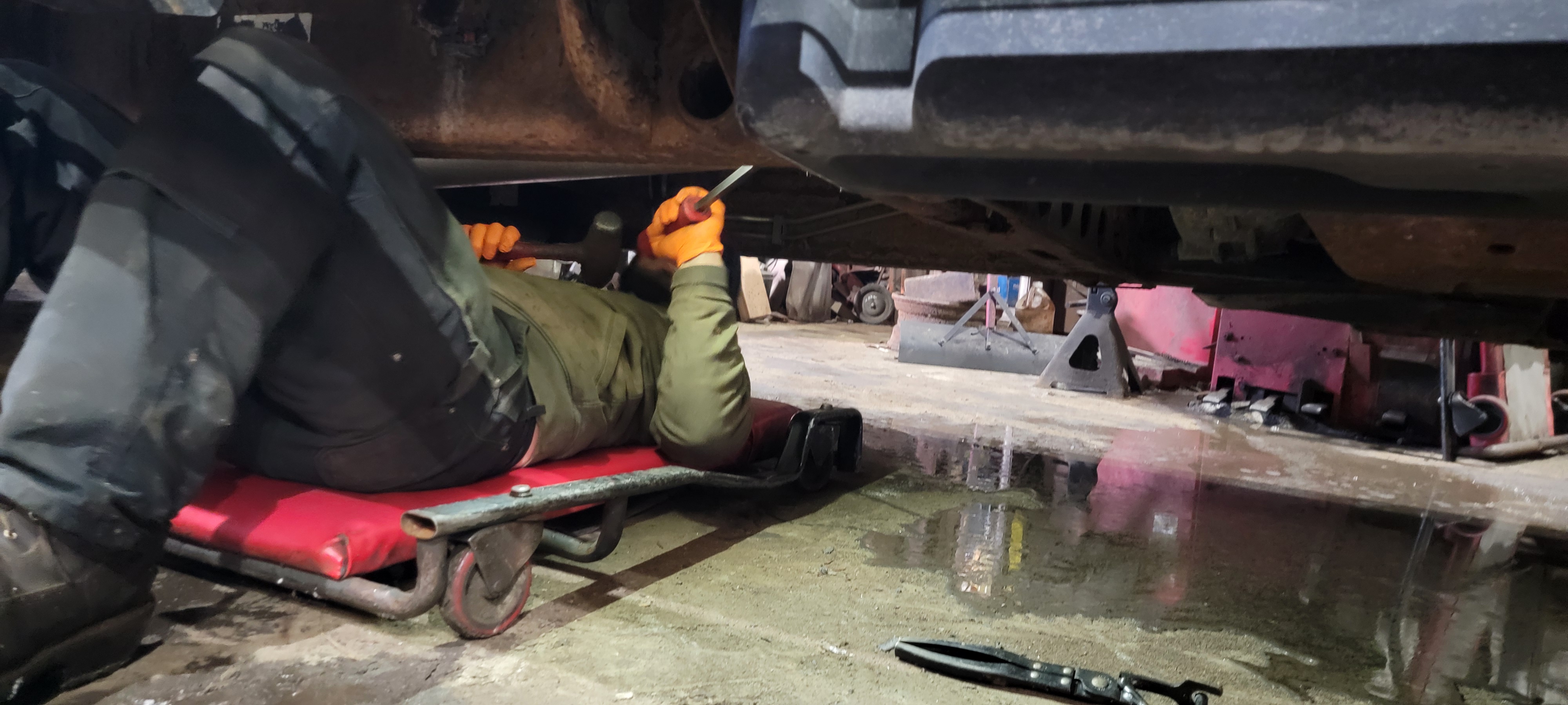 Mechanic Repairing Truck Undercarriage